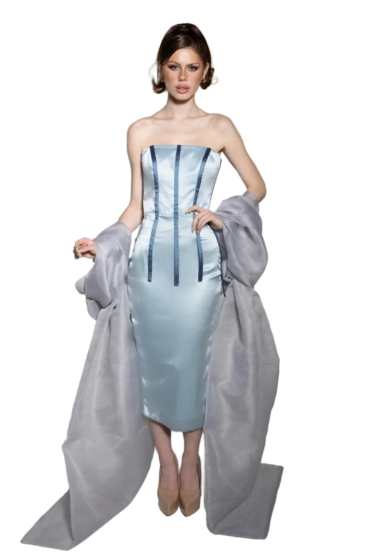 A model wearing a sky blue silk midi dress with blue silk taffeta stripe details and a silver silk organza shawl.